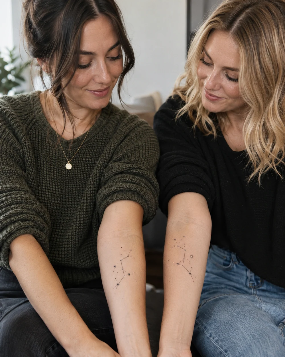 An adult woman displaying matching fine-line constellation tattoos on her inner forearms