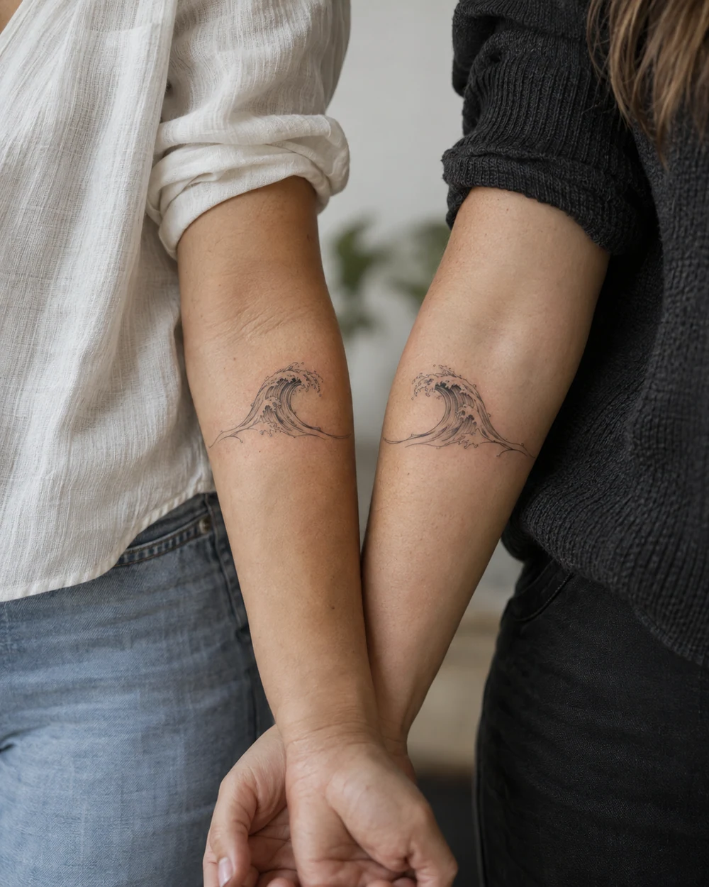 Mirrored fine-line curling wave tattoos with inward-facing crests on two forearms